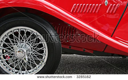 stock-photo-side-of-a-red-british-mg-close-up-of-tire-rim-and-fender-3285162.webp